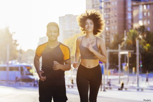 Man and woman jogging in a city